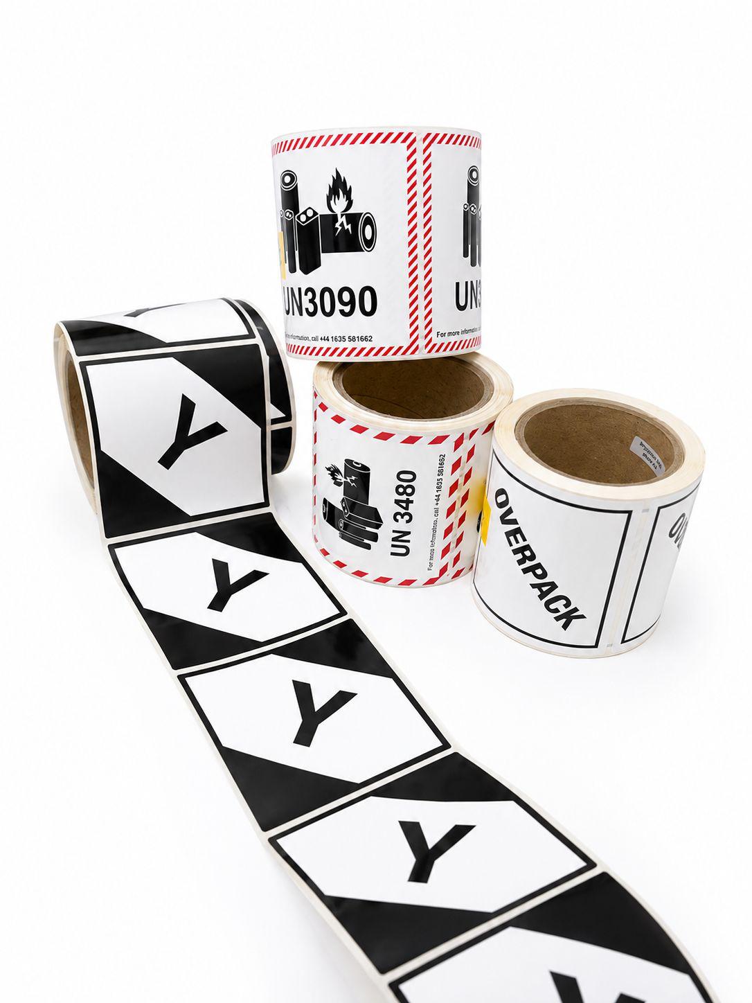 Rolls of hazard labels and direct thermal labels, including lithium battery UN3090 and UN3480 warnings and overpack labels